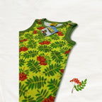 Green sleeveless dungarees with red berry pattern on a white background