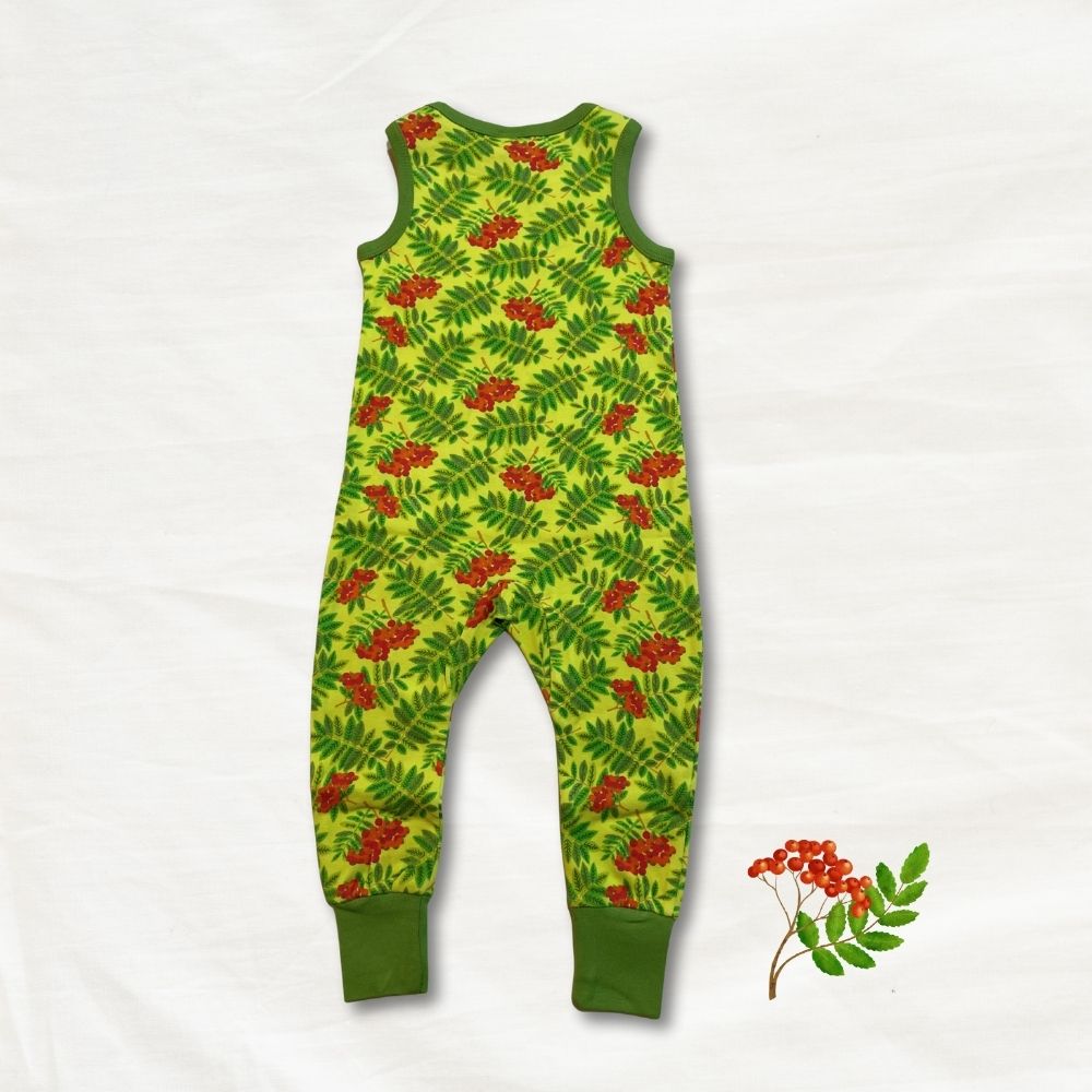 Green children's romper with red berry pattern on a white background