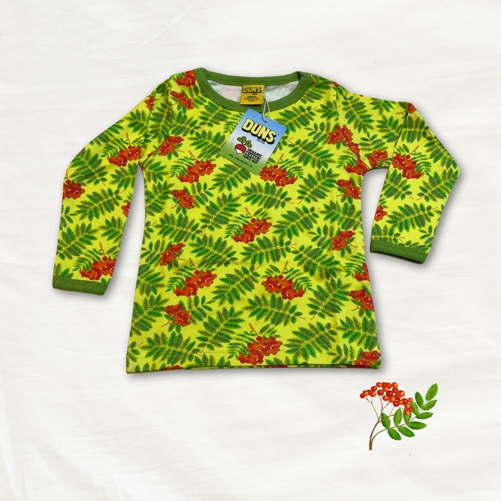 Green long-sleeve shirt with red berry pattern on a white background