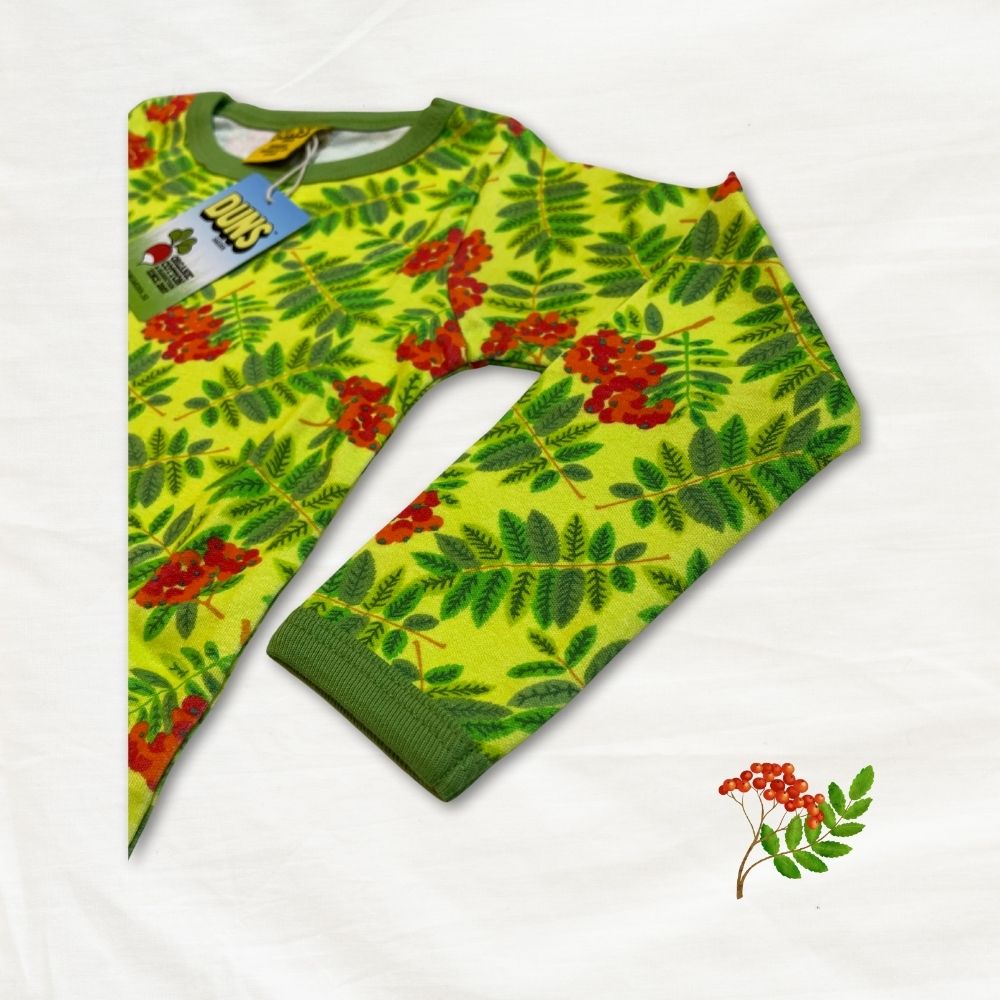 Green sweater with red floral pattern on a white background