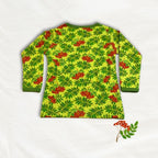 Long-sleeve shirt with a green leaf and red berry pattern on a white background
