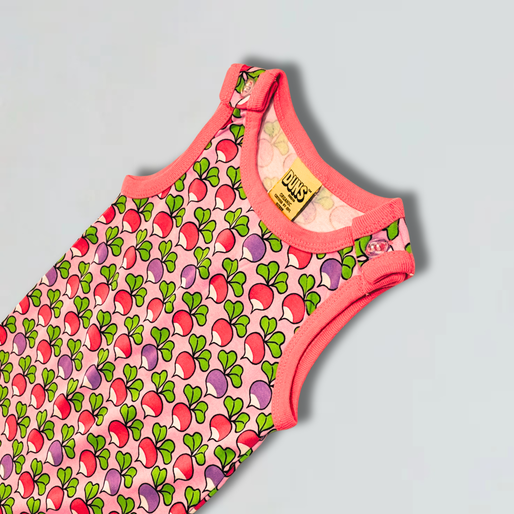 Children's sleeveless top with colorful pattern on a gray background