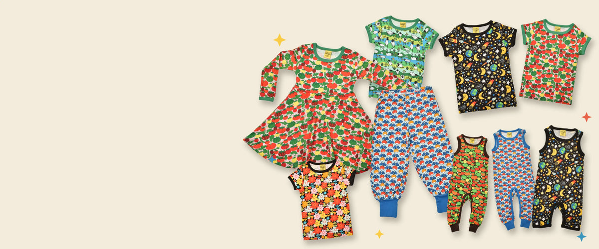 A collection of colorful baby clothing displayed on a light beige background, 