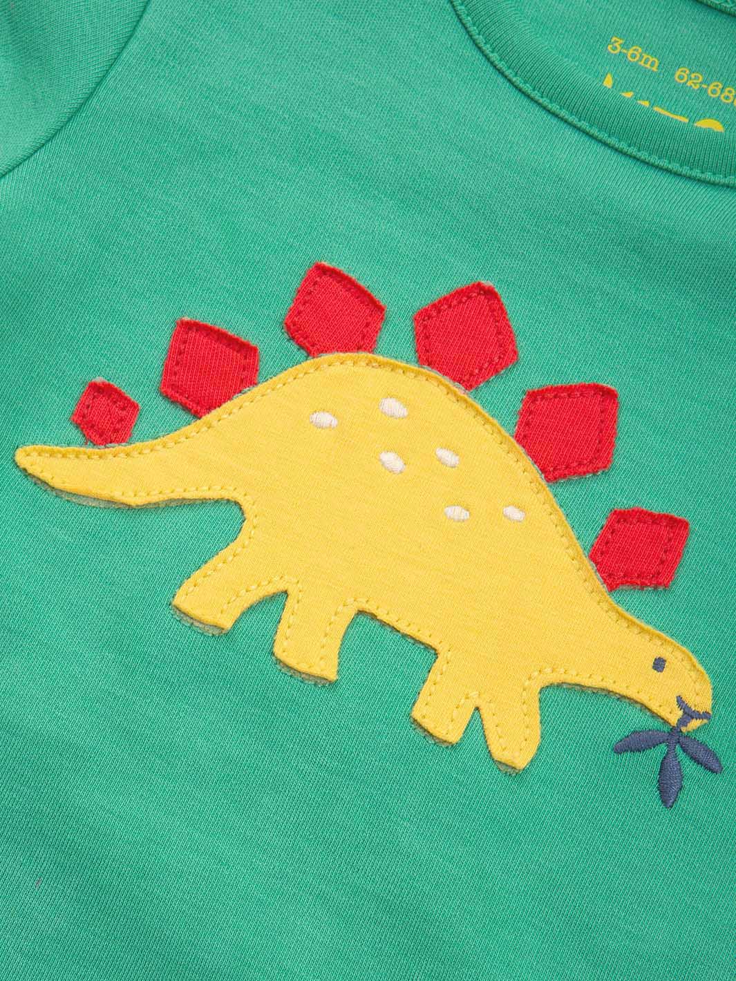Green shirt with a yellow dinosaur applique on a green background