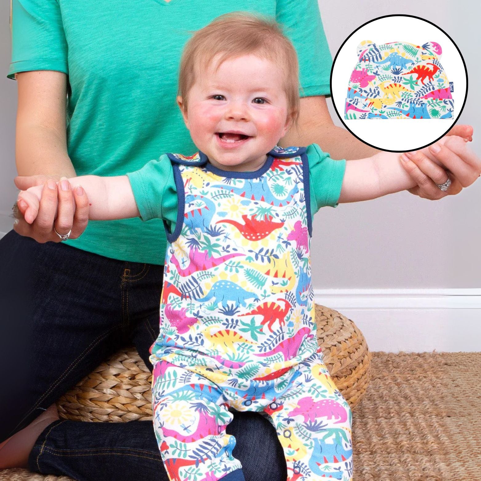 Child wearing a colorful dinosaur-patterned outfit with a close-up inset of the pattern.