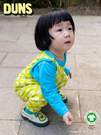 Child wearing a colorful outfit with Duns Sweden logo in the corner