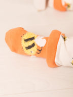 Orange socks with lion design on a light background