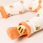 Baby socks with orange and white pattern on a light background