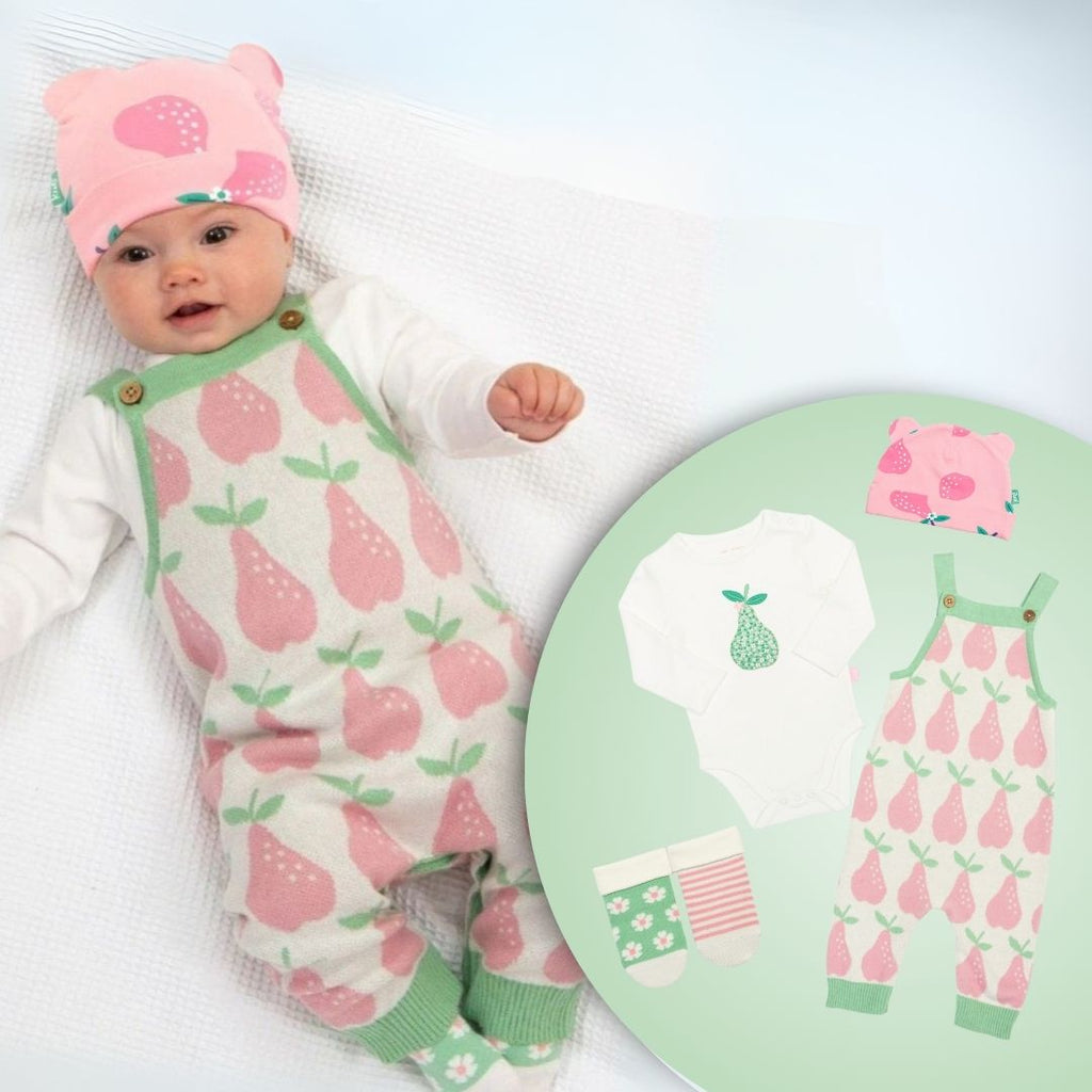 Baby in pink and green outfit with matching design on a round chart