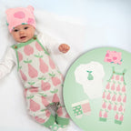 Baby in pink and green outfit with matching design on a round chart