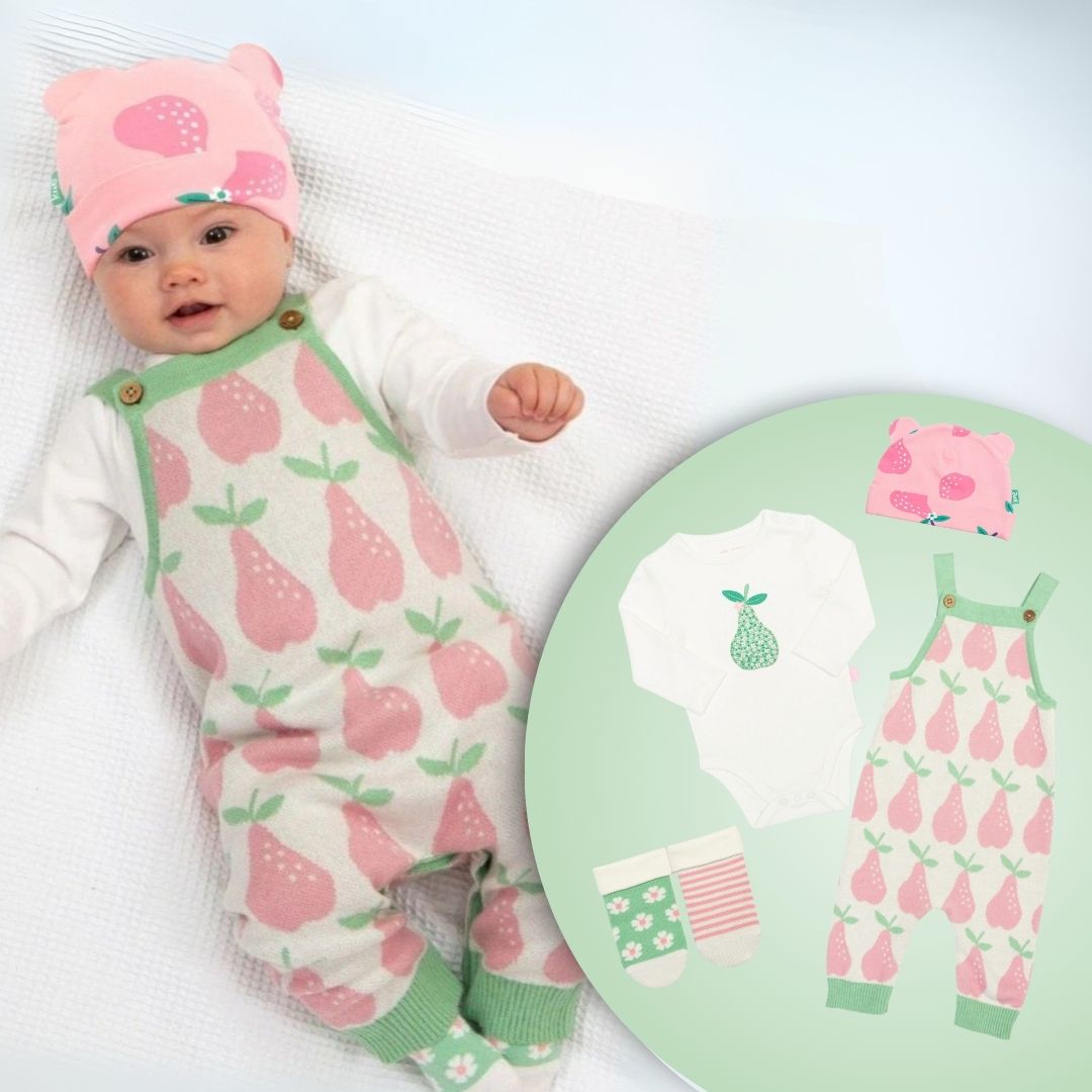 Baby in pink and green outfit with matching design on a round chart