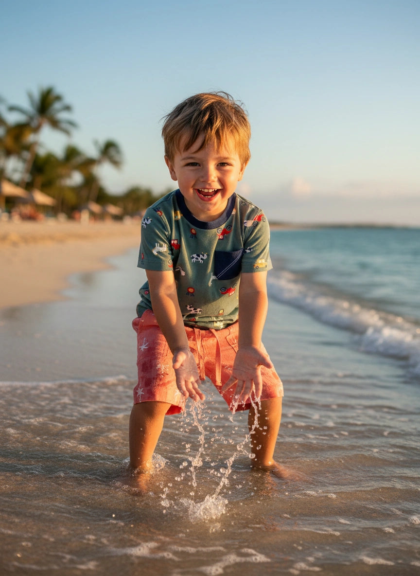 Child playing in the water at the beach with palm trees in the background