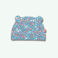 Floral patterned baby hat with bear ears on a white background