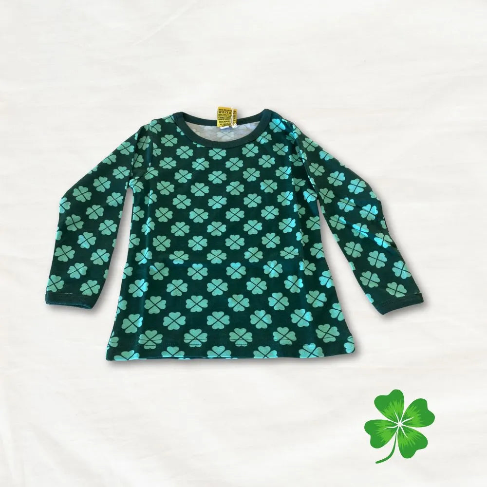 Green long-sleeve shirt with blue clover pattern on a white background