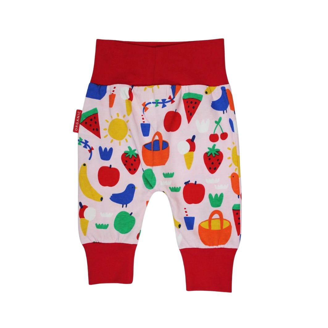 Colorful children's pants with fruit and vegetable pattern on a white background