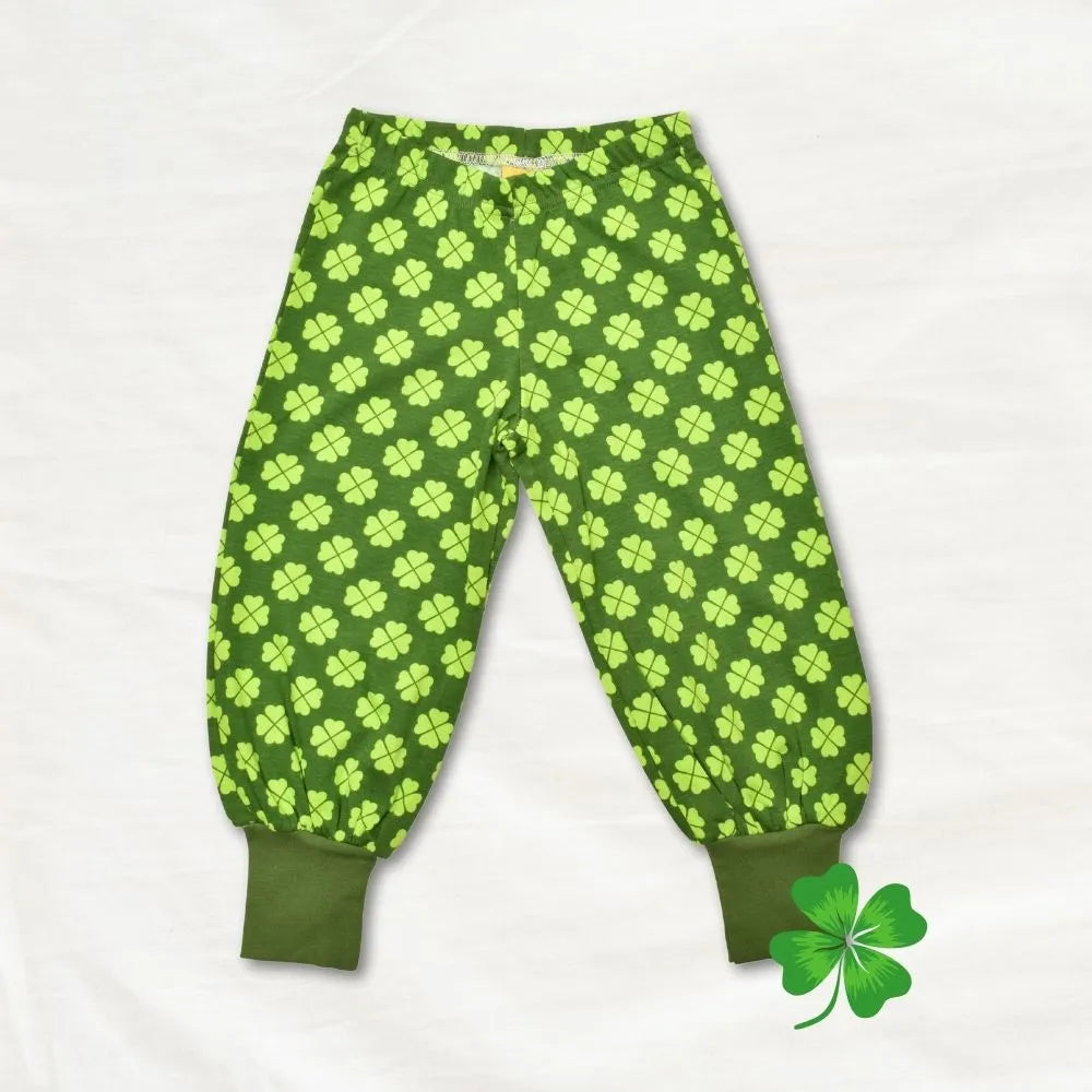 Green children's pants with clover pattern on a white background