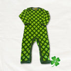 Green baby onesie with clover pattern on a white background