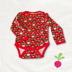 Red baby onesie with green and pink pattern on a white background