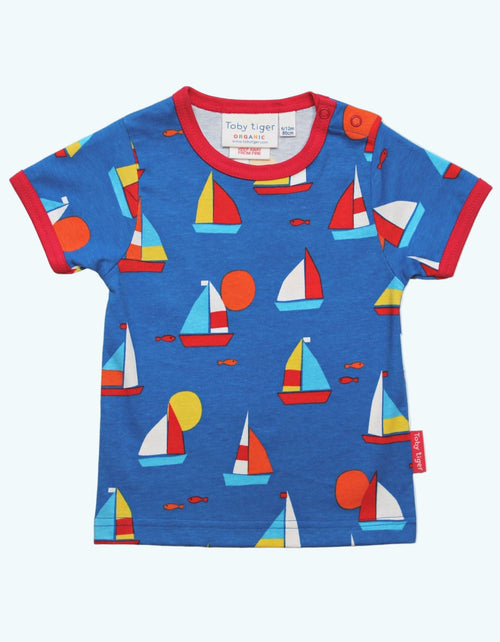 Children's blue t-shirt with colorful sailboat pattern on a white background