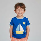 Boy wearing Toby tiger applique sailboat tshirt  in a park