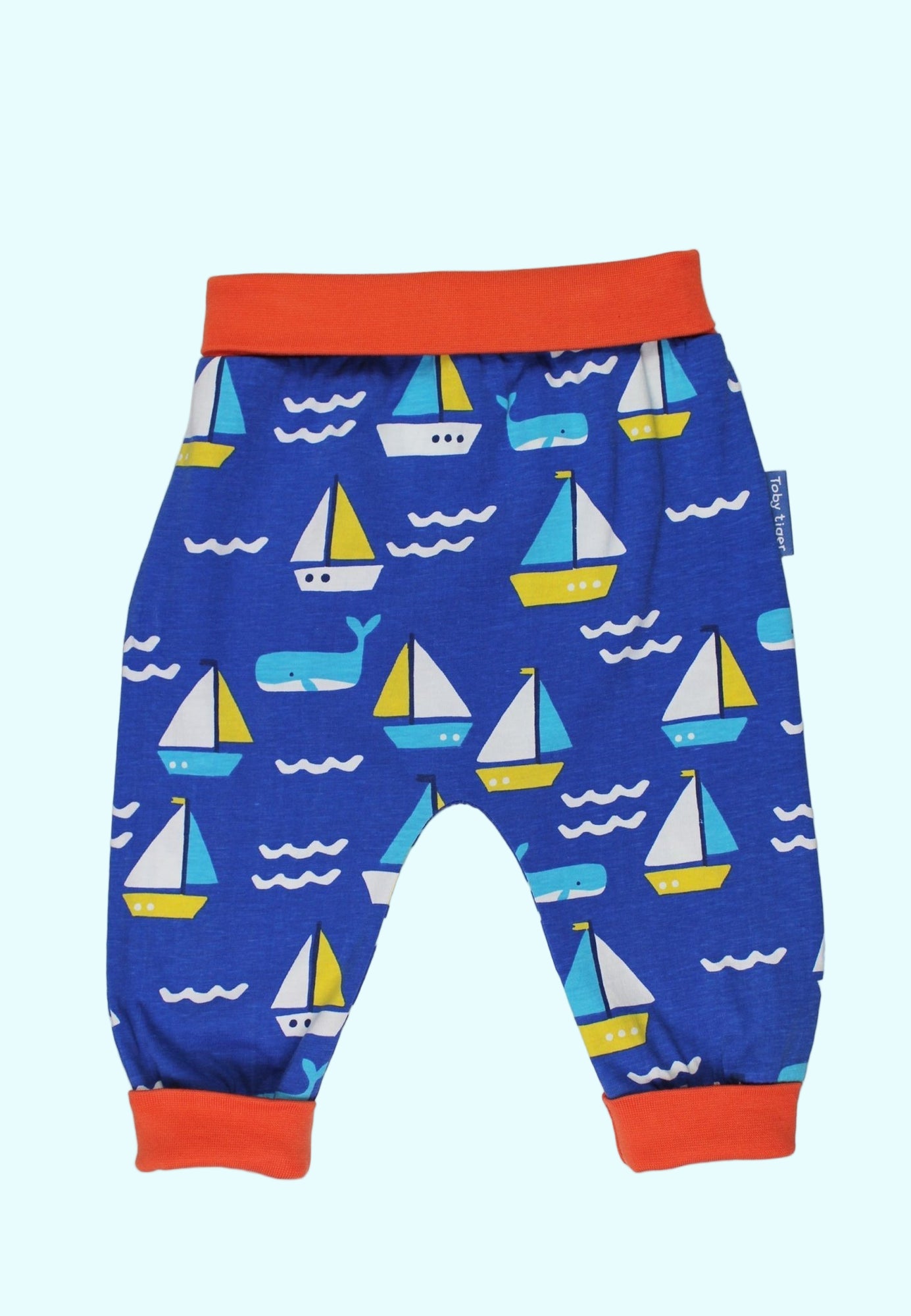 Blue children's pants with sailboat pattern on a white background