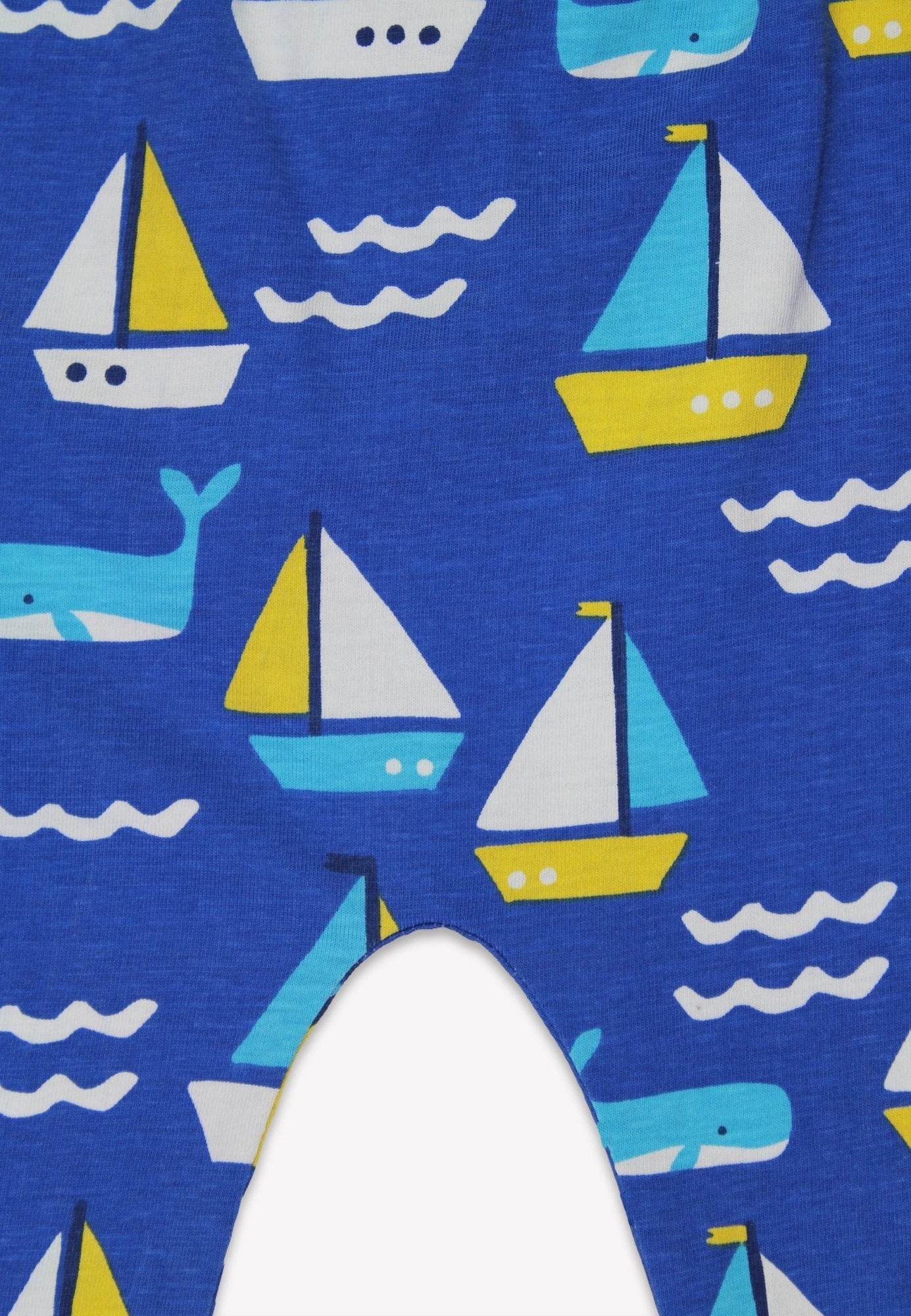 Fabric with sailboat and whale pattern on a blue background