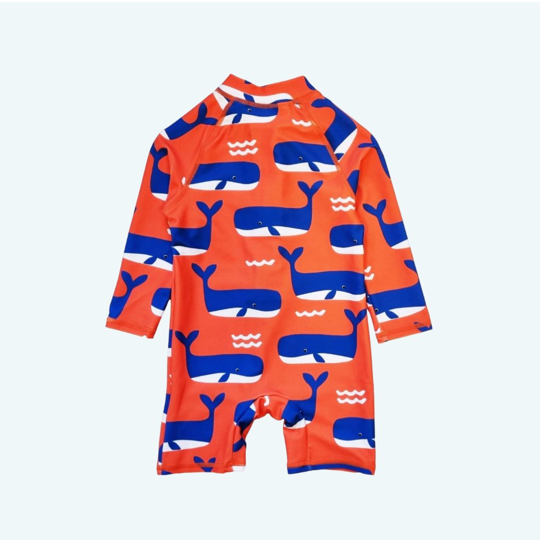 Children's swimsuit with whale pattern on a light blue background