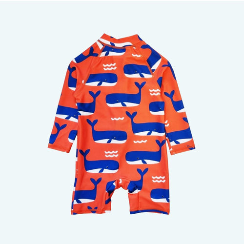 Children's swimsuit with whale pattern on a light blue background