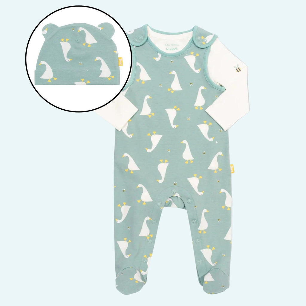 Baby onesie with duck pattern and matching hat on a light blue background