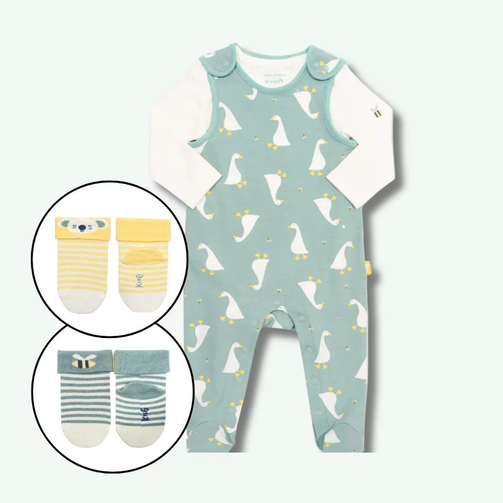 Baby romper with duck pattern and inset images of baby socks on a light blue background