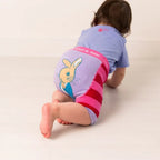 Child wearing a diaper with a cartoon character on a plain background