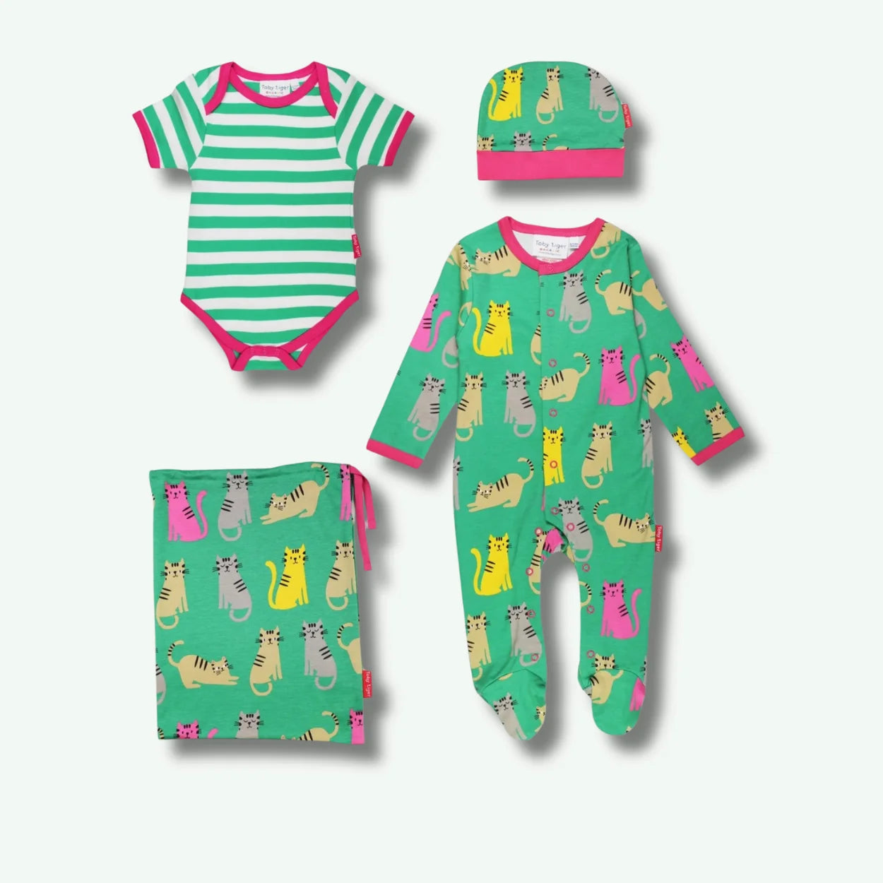 Set of baby clothing with striped onesie, pajama, hat, and pouch on a white background