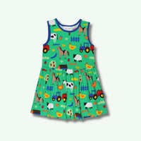 Children's dress with farm animal pattern on a white background