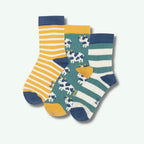 Two pairs of children's socks with cow and stripe patterns on a white background