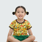 Child wearing a colorful shirt with animal prints on a plain background