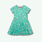 Green dress with dog pattern on a white background