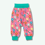 Pink children's pants with floral and bee pattern on a white background