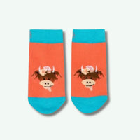 Pair of socks with a cow design on a white background