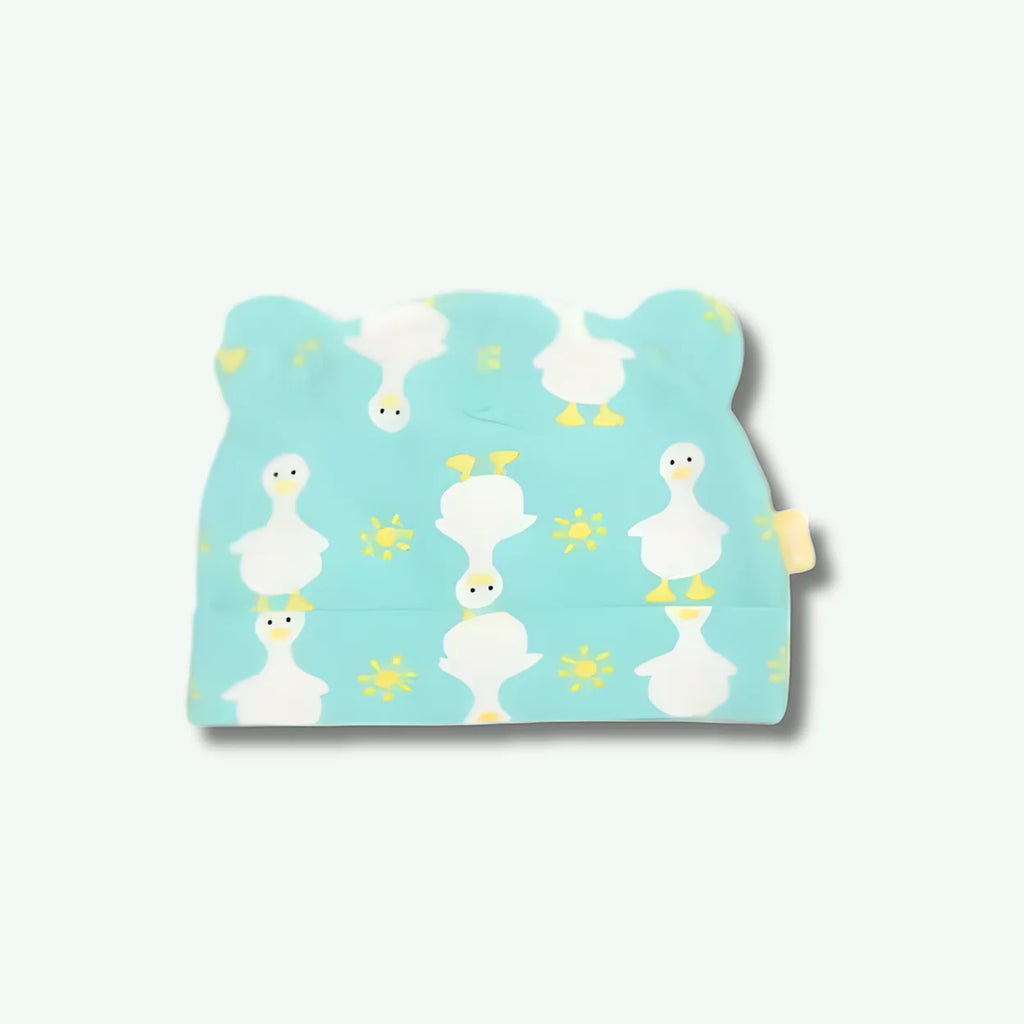 Baby bib with duck pattern on a light blue background