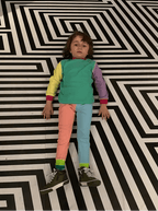 Child standing on a black and white geometric patterned floor
