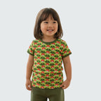 Child wearing a green t-shirt with red and white pattern on a plain background