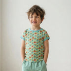 Boy wearing bright organic kids clothes in a well lit room