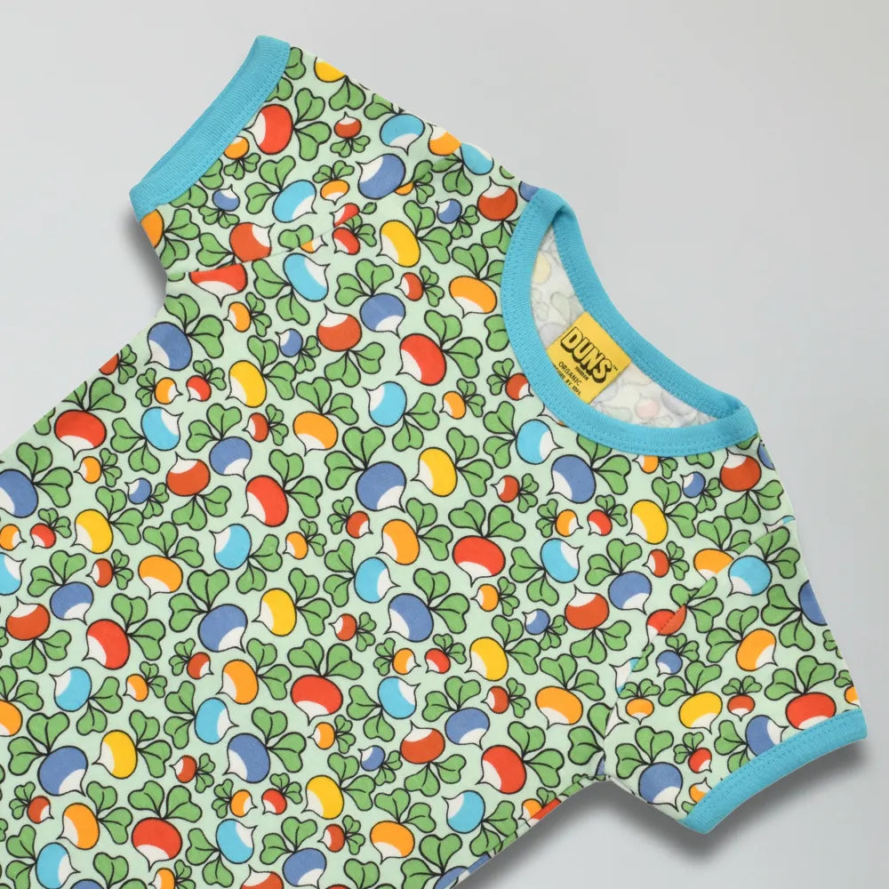 Colorful baby shirt with radish pattern on a light gray background