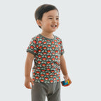 Child wearing a patterned shirt with a white background