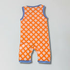 Orange romper with paw print pattern on a gray background