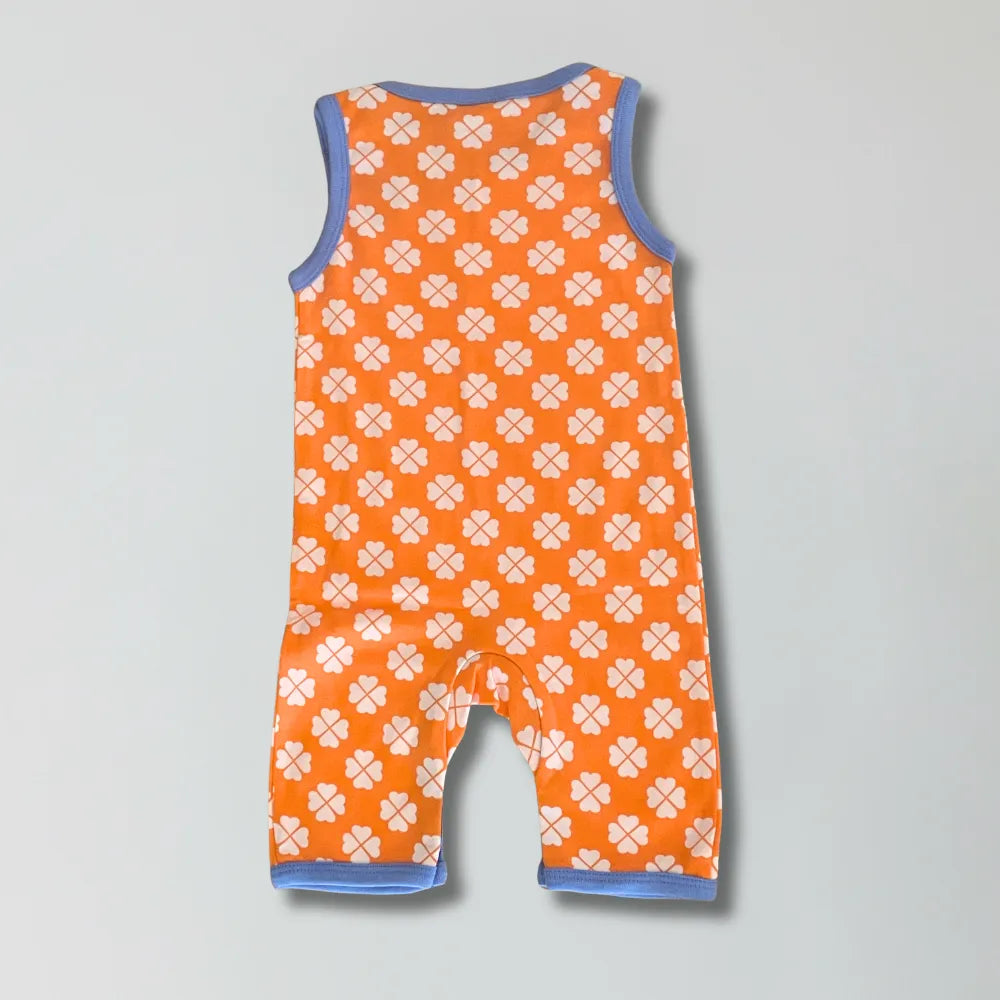 Orange romper with paw print pattern on a gray background