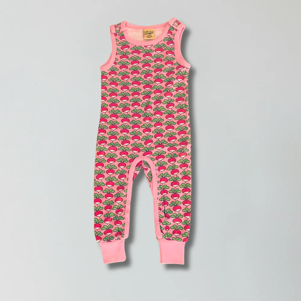 Pink children's romper with radish pattern on a gray background