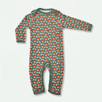 Children's onesie with red mushroom pattern on a green background