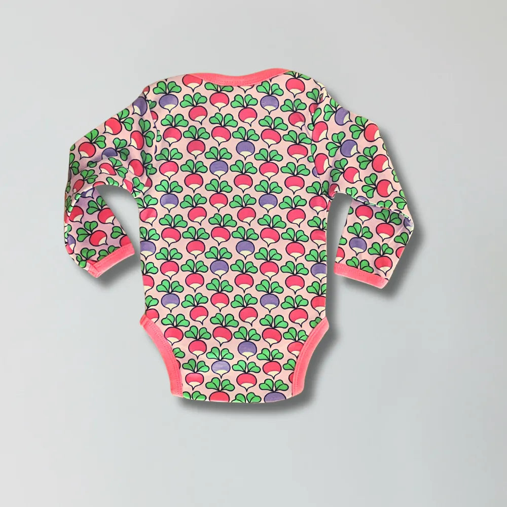 Baby onesie with colorful radish pattern on a gray background