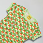 Green short sleeve top with radish pattern on a gray background